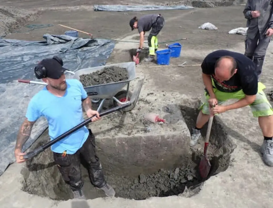 Steffen Hansen et Christian Løchsen Rødsrud aident à creuser un profond trou.